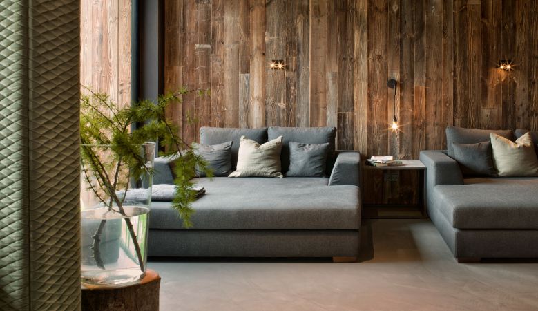 Luxurious alpine spa hotel nestled in Austrian mountains, featuring modern wood architecture and panoramic floor-to-ceiling windows