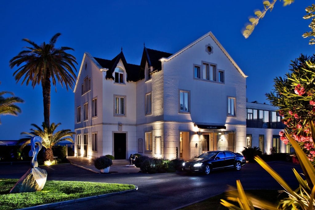 Luxurious whitewashed Scenset Hotel perched on rocky coastline, overlooking azure waters of Portuguese seaside with elegant balconies and modern architectural design