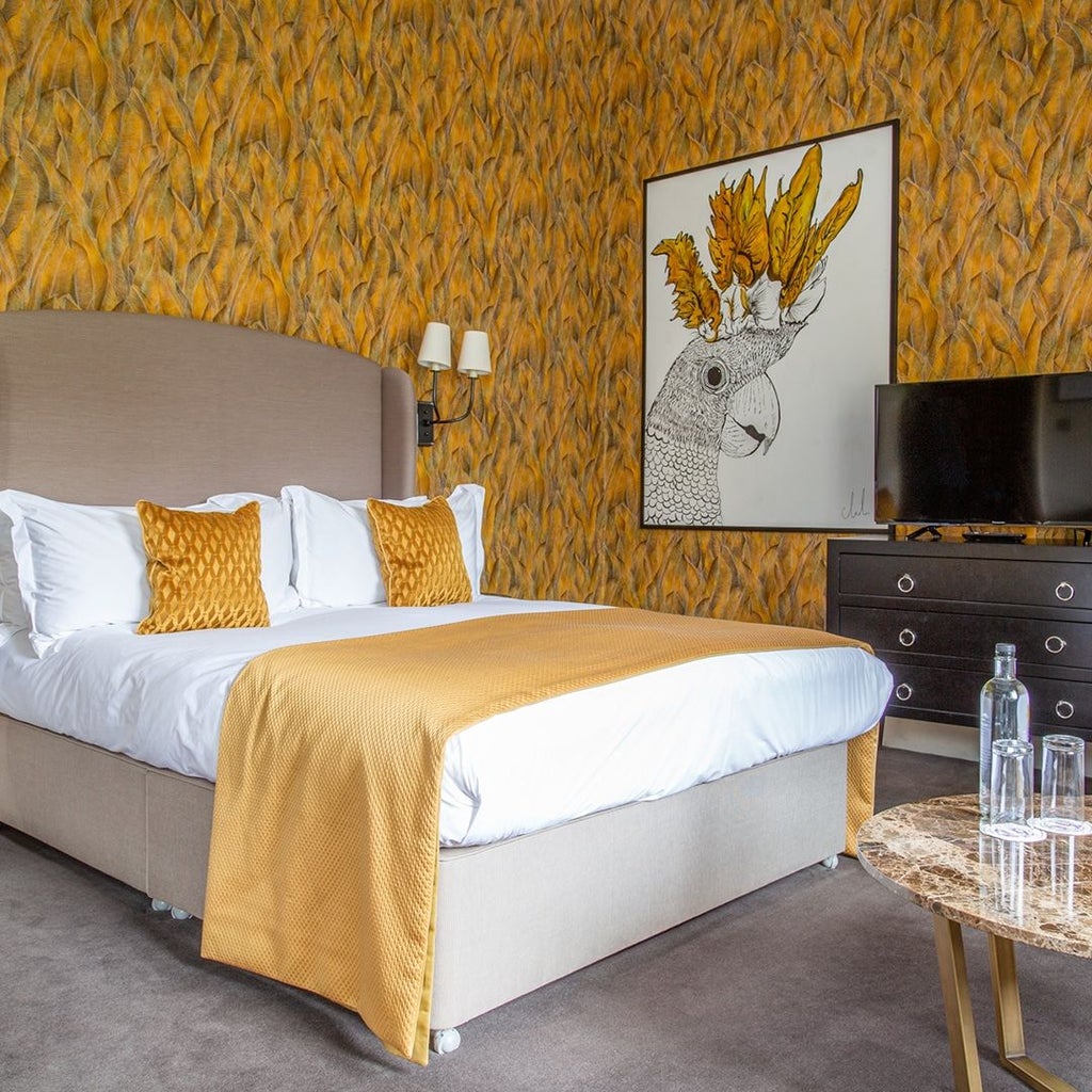 Elegant four-poster bed with plush white linens in luxurious suite, featuring soft neutral tones and refined decor at boutique hotel in United Kingdom