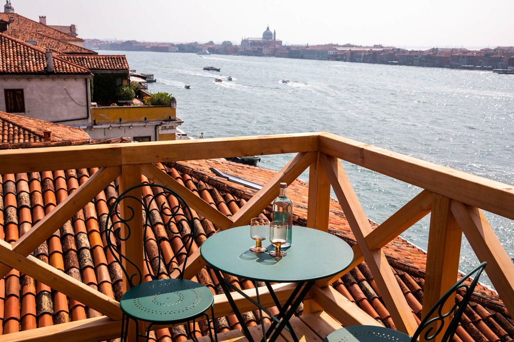 Elegant Venetian-style hotel facade with ornate windows, traditional architecture, and warm terracotta tones overlooking a serene canal in Italy