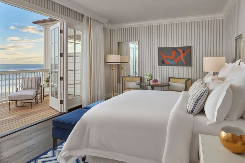 Luxurious coastal terrace with ocean view, featuring elegant outdoor seating and modern design at Rosewood Miramar Beach resort's Beach House Guestrooms