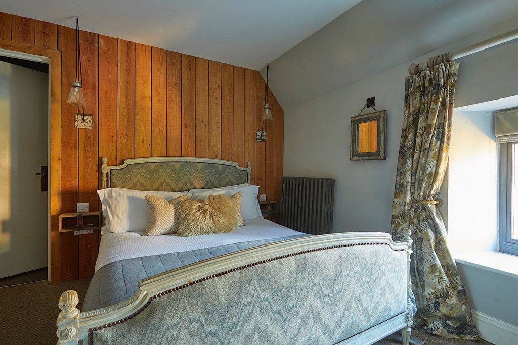 Cozy small double hotel room with elegant neutral decor, soft bed linens, wooden furnishings, and warm ambient lighting at Timbrell's Yard in United Kingdom