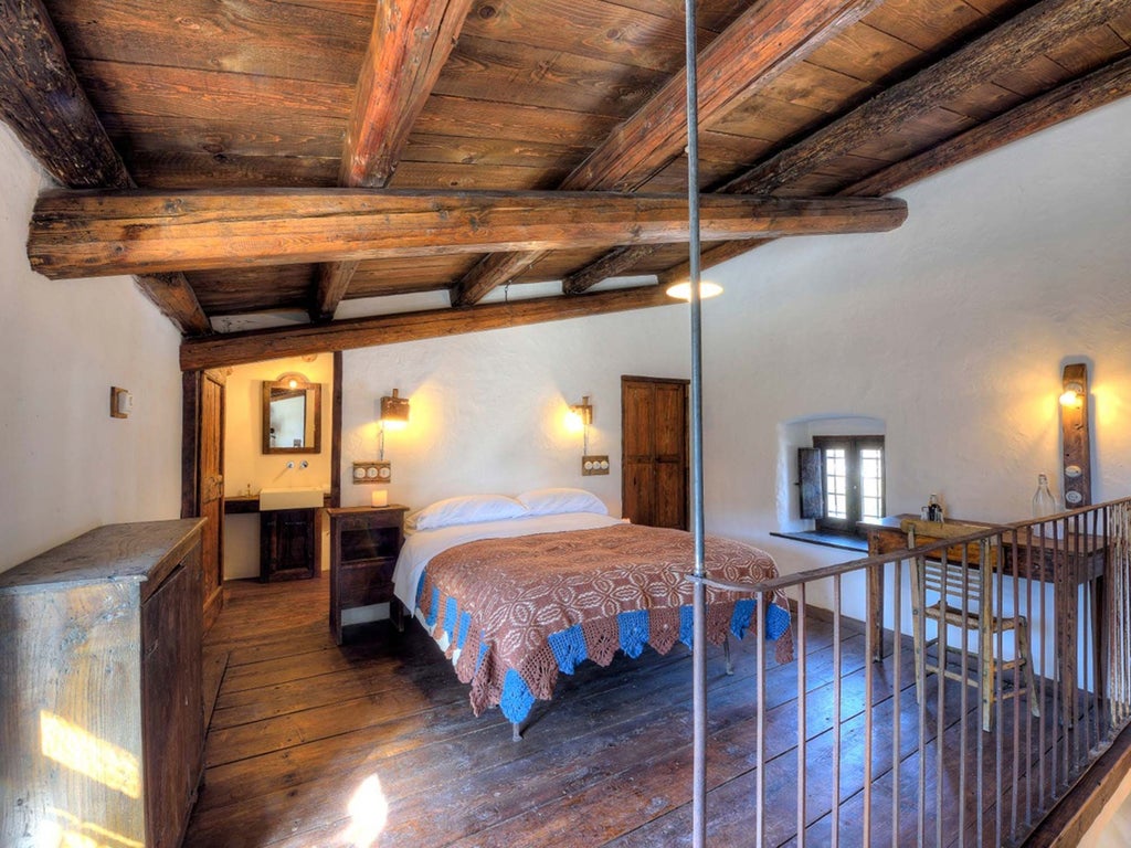 Rustic stone-walled hotel room in scenset, Italy, with traditional wooden furnishings and panoramic view of historic bell tower through arched window