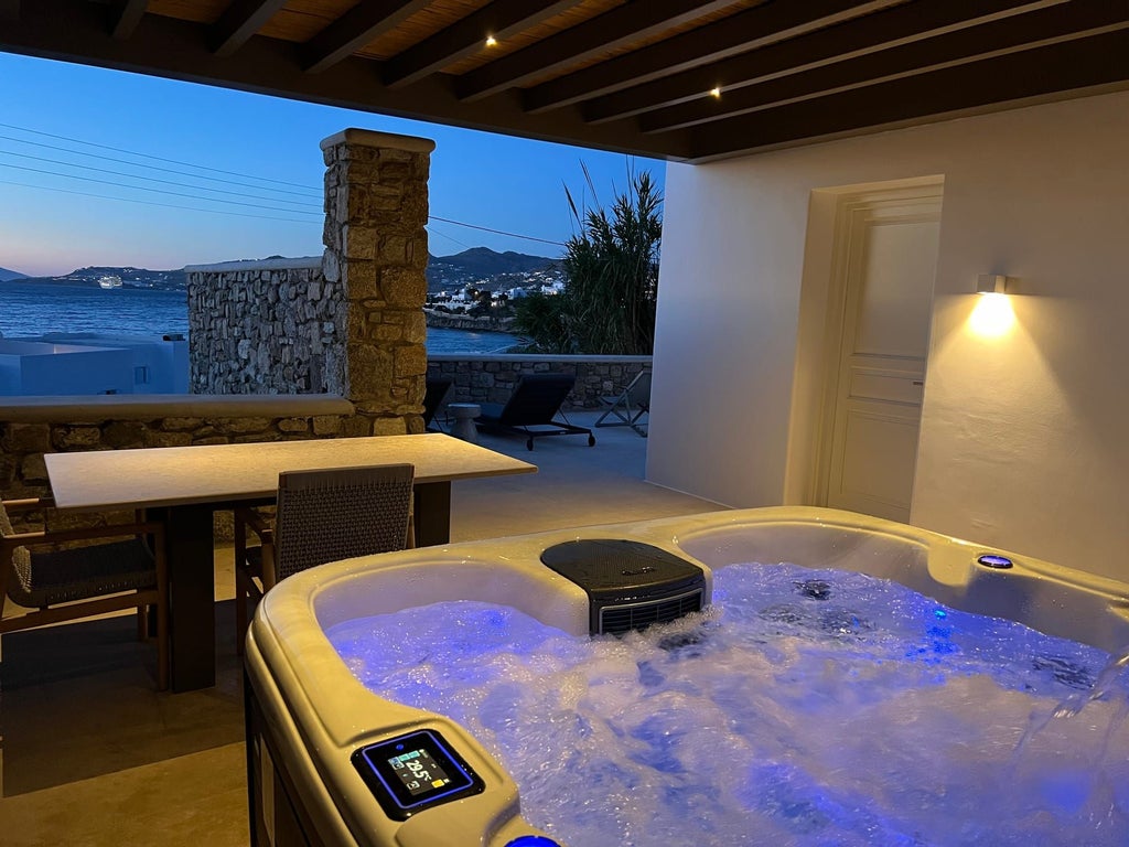 Luxurious two-bedroom villa in Mykonos with expansive sea view, private heated pool, and elegant Mediterranean design against scenic coastal backdrop