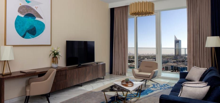 Modern, spacious Superior One Bedroom Apartment with sleek furniture, floor-to-ceiling windows overlooking Dubai's cityscape at the Avani+ Palm View Hotel & Suites