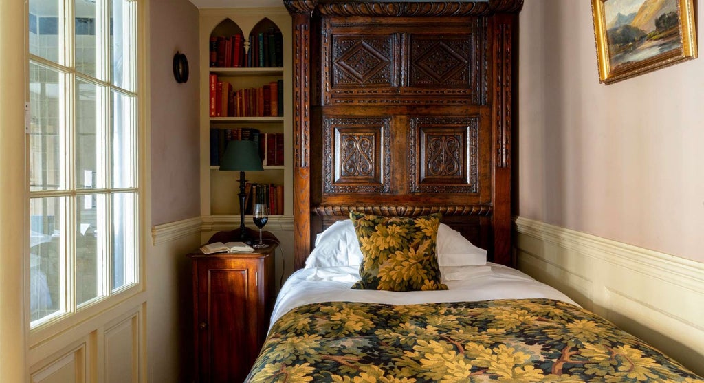 Elegant club single room at Hazlitt's boutique hotel, featuring plush bedding, antique furnishings, and sophisticated dark wood accents in a refined United Kingdom setting