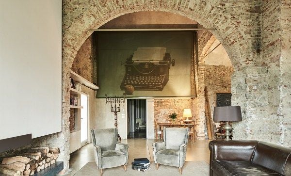 Luxurious Scenset Lofts in Florence, stone walls blend with modern minimalist design, warm wood tones, panoramic windows overlooking Tuscan landscape