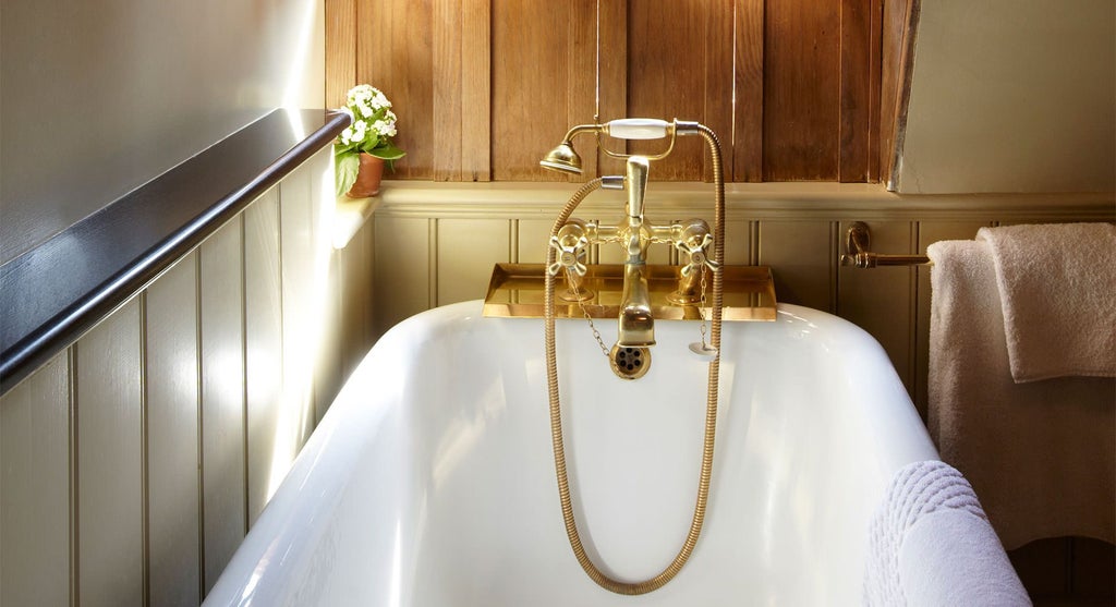 Elegant Club Double room at The Rookery, featuring luxurious cream and brown decor, plush bedding, and refined period-style furnishings in a United Kingdom boutique hotel