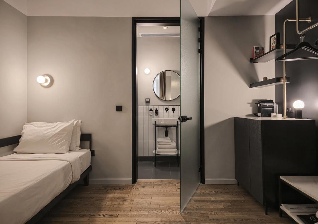 Luxurious XL room at The Modernist Thessaloniki with minimalist design, crisp white bedding, sleek furniture, and large windows overlooking the city