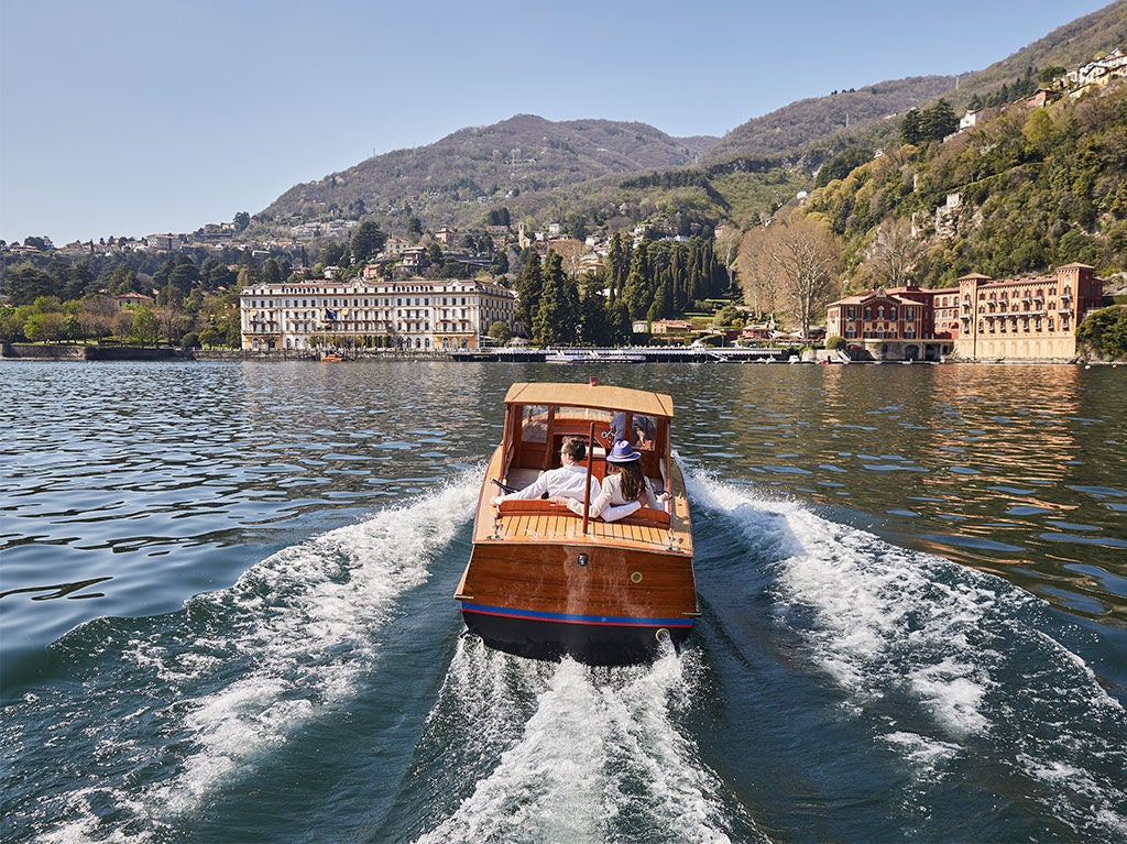 Renaissance-style luxury hotel Villa d'Este on Lake Como, featuring manicured gardens, ornate fountains and classical architecture at sunset