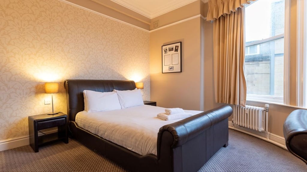 Elegant modern suite with plush king bed, floor-to-ceiling windows, luxurious marble bathroom, and contemporary design at a prestigious United Kingdom hotel