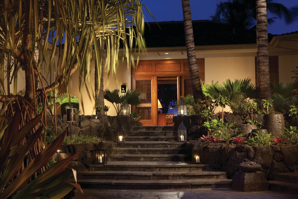 Infinity pool overlooking Pacific Ocean at sunset, palm trees frame luxurious oceanfront terrace with elegant lounge chairs and cabanas