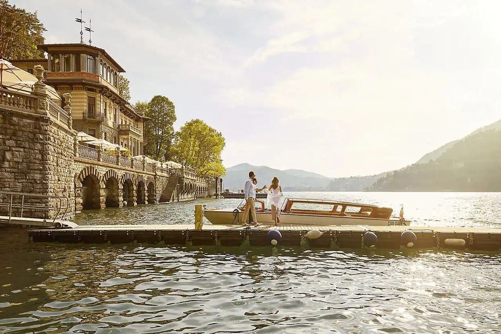 Elegant Mandarin Lake Como hotel perched on Italian hillside overlooking serene waters, with manicured gardens and infinity pool