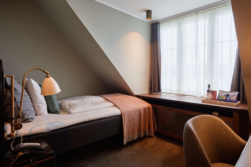 Elegant single deluxe hotel room with modern Danish design, minimalist furnishings, soft neutral tones, and premium bedding in Hotel Skt. Annæ, Copenhagen