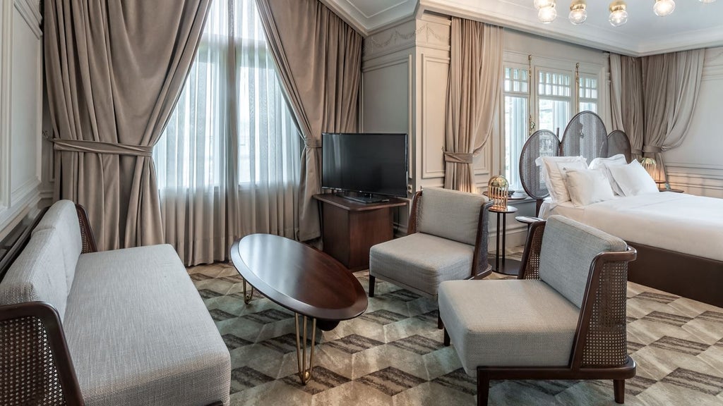 Luxurious penthouse suite overlooking Bosphorus, featuring modern elegant decor, floor-to-ceiling windows, and stunning panoramic cityscape of Istanbul at sunset