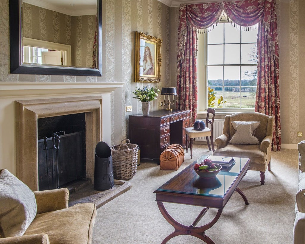 Elegant grand suite with plush king-sized bed, refined classic decor, and expansive windows overlooking manicured gardens at luxurious United Kingdom hotel retreat