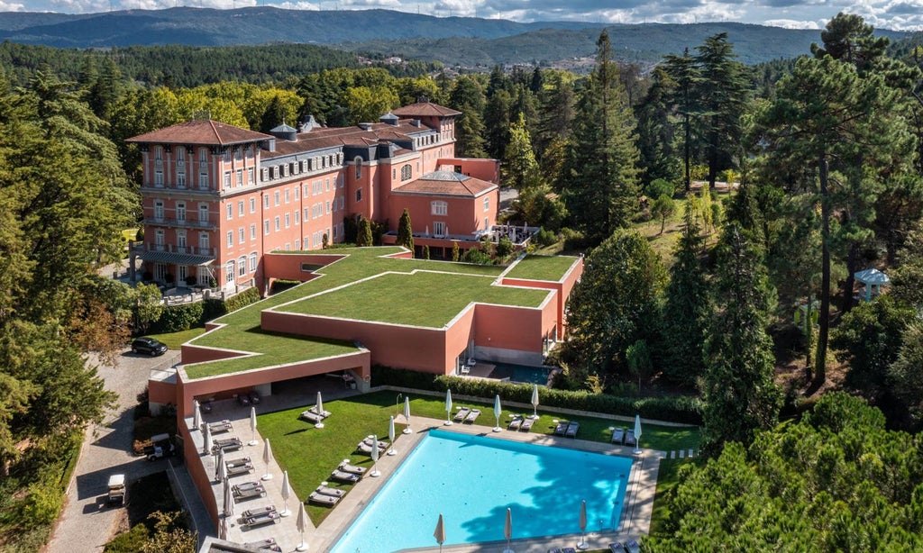 Elegant Vidago Palace Hotel nestled in lush Portuguese landscape, featuring grand architecture, manicured gardens, and neoclassical luxury amid verdant surroundings