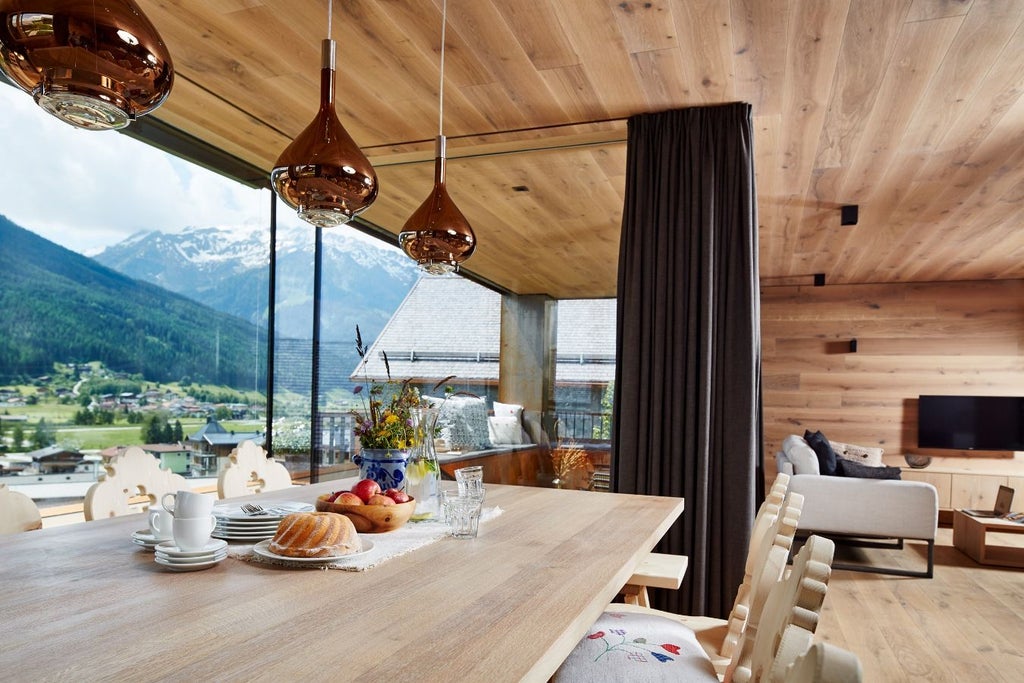 Elegant alpine hotel nestled in Austrian mountains with wooden balconies, lush gardens, and panoramic valley views at golden hour