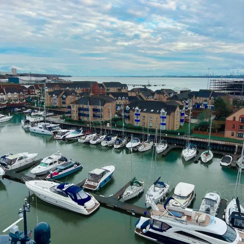 Luxurious waterfront hotel with modern glass facade overlooking Southampton harbour, featuring sleek architecture and elegant maritime-inspired design