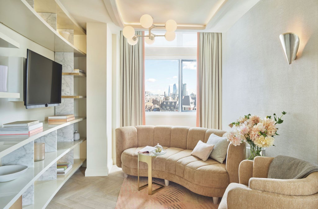 Luxurious hotel room at One Aldwych featuring elegant contemporary design, plush bedding, modern amenities, and sophisticated city-inspired decor in neutral tones