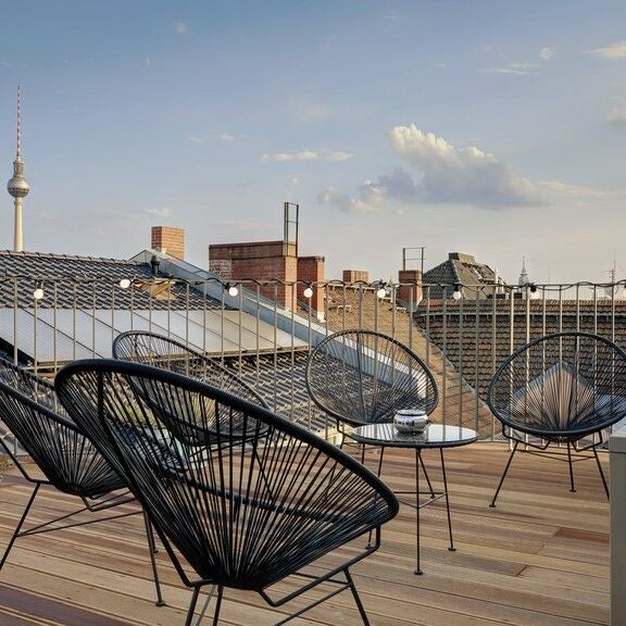 Modern luxury penthouse with panoramic city views, sleek minimalist design, floor-to-ceiling windows, and elegant contemporary furnishings in urban Germany