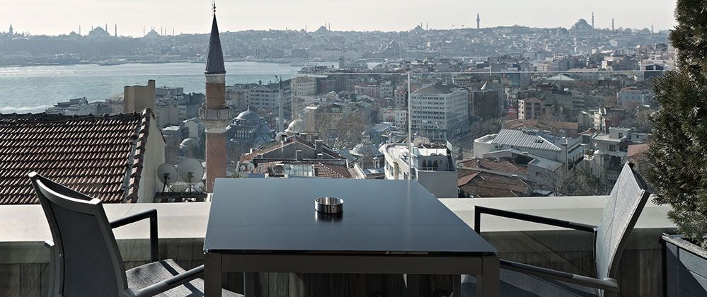 Spacious king bedroom at Scenset Istanbul Hotel with elegant modern design, expansive terrace overlooking city skyline, warm neutral tones and contemporary furnishings