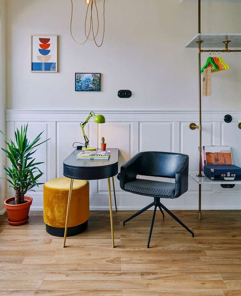 Stylish modern hotel room with minimalist design, large windows, natural light, and contemporary furnishings in urban Berlin hotel setting