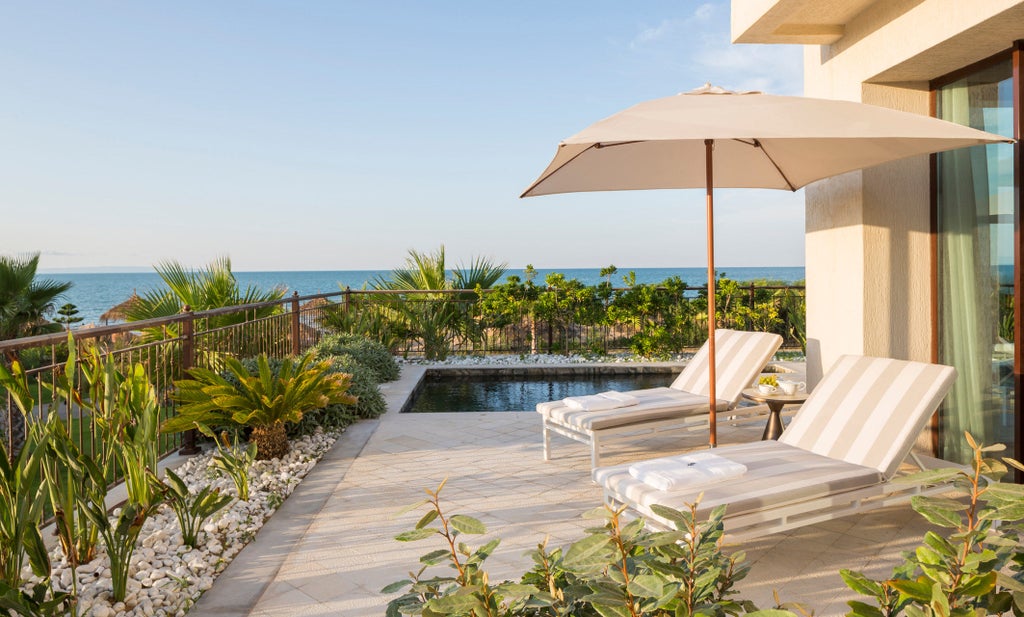 Opulent beachfront hotel in Tunisia with white Mediterranean architecture, palm-lined pools, and sweeping views of the azure sea