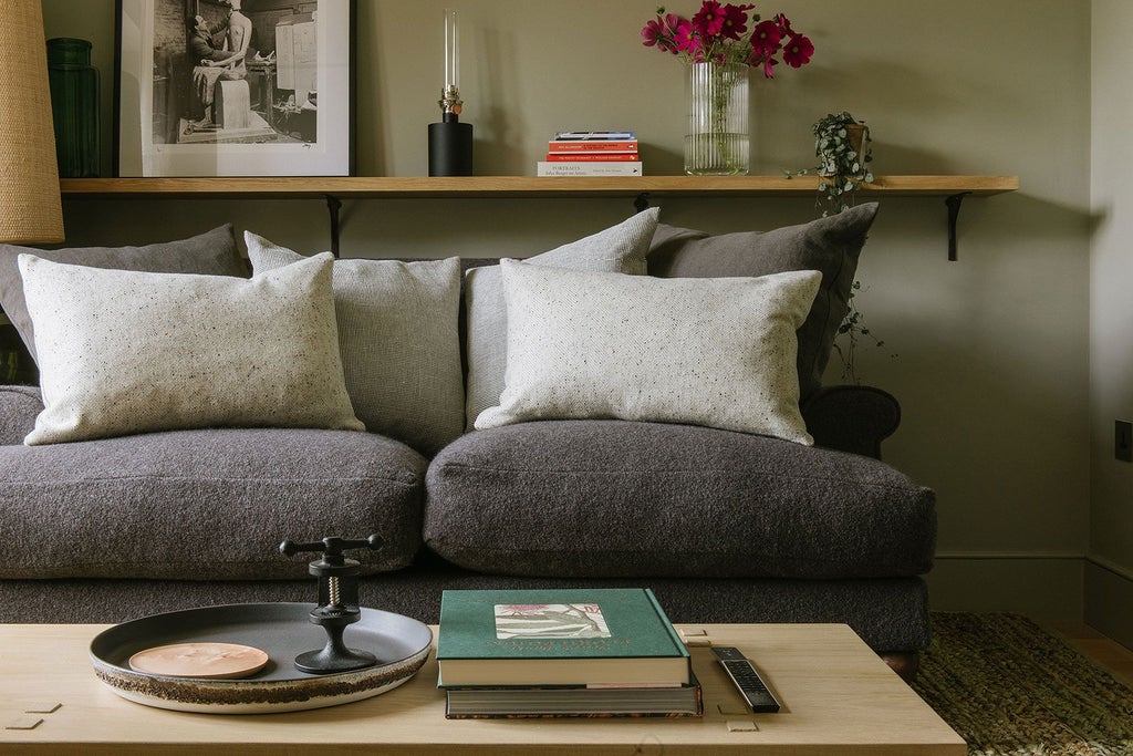 Elegant neutral-toned luxury hotel room with plush bedding, soft natural light, and refined minimalist design at scenic countryside retreat