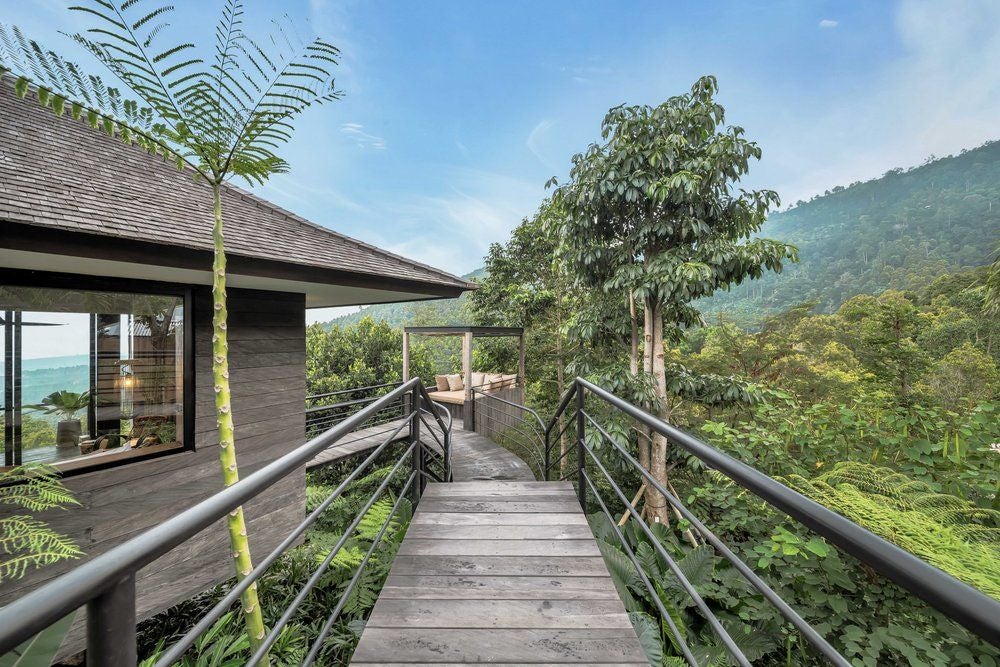 Luxurious studio cabin with floor-to-ceiling windows, floating private cabana, infinity pool overlooking lush Balinese mountain jungle