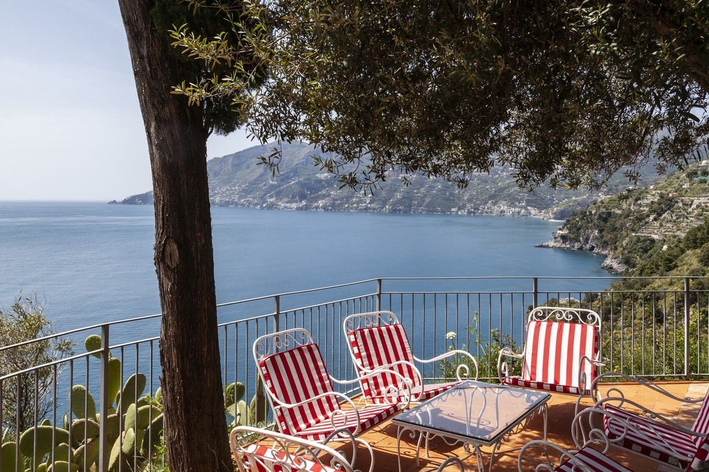 Elegant medieval watchtower villa perched on Amalfi cliffs, featuring terraced gardens, lemon groves, and coastal views down 